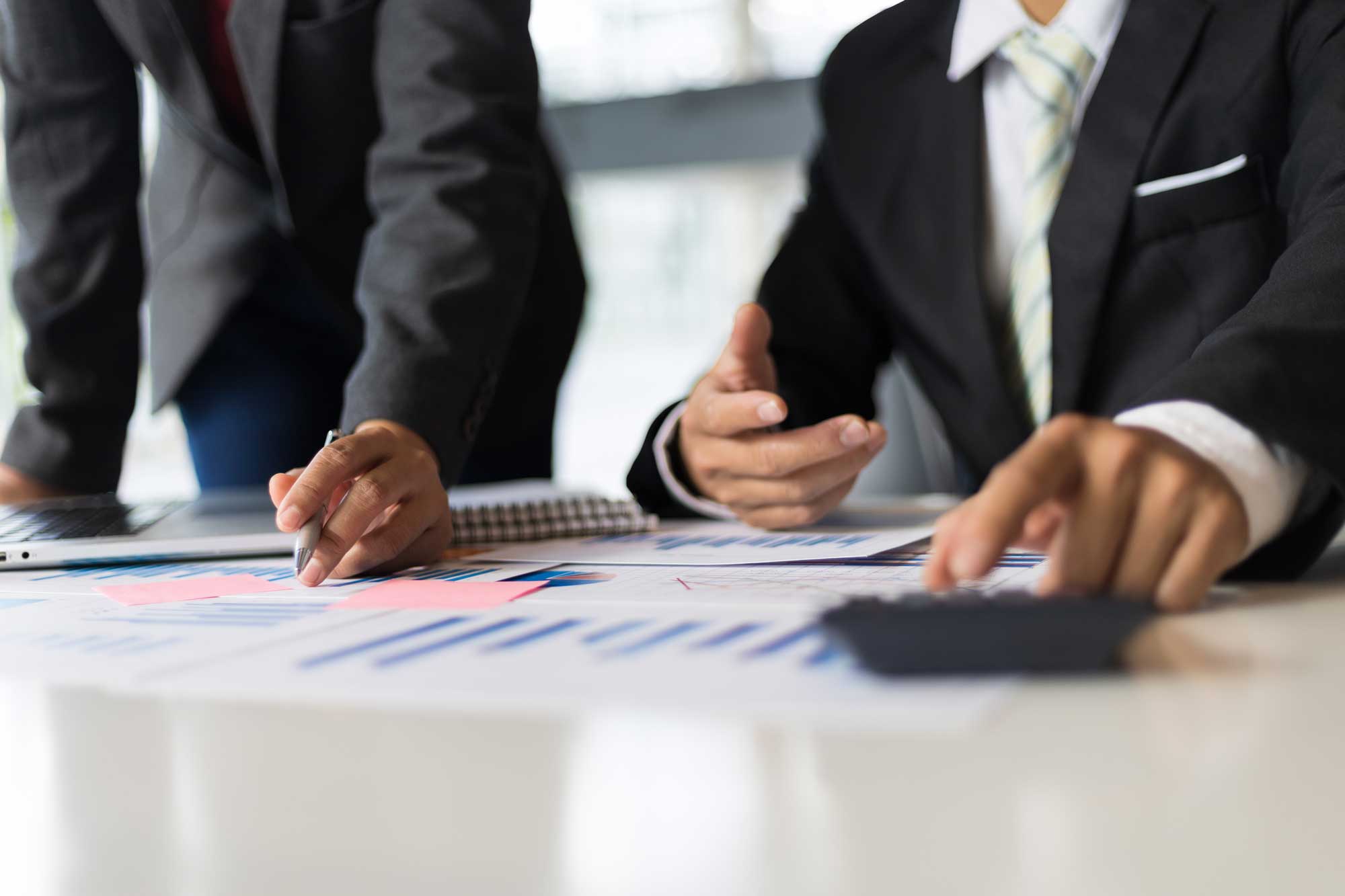 close up of professionals writing on a notebook