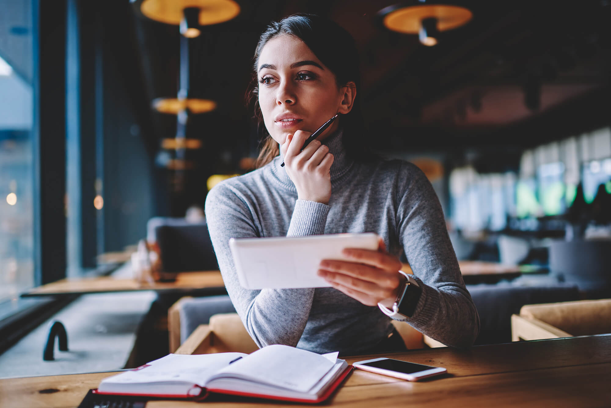 woman looking at documents and thinking